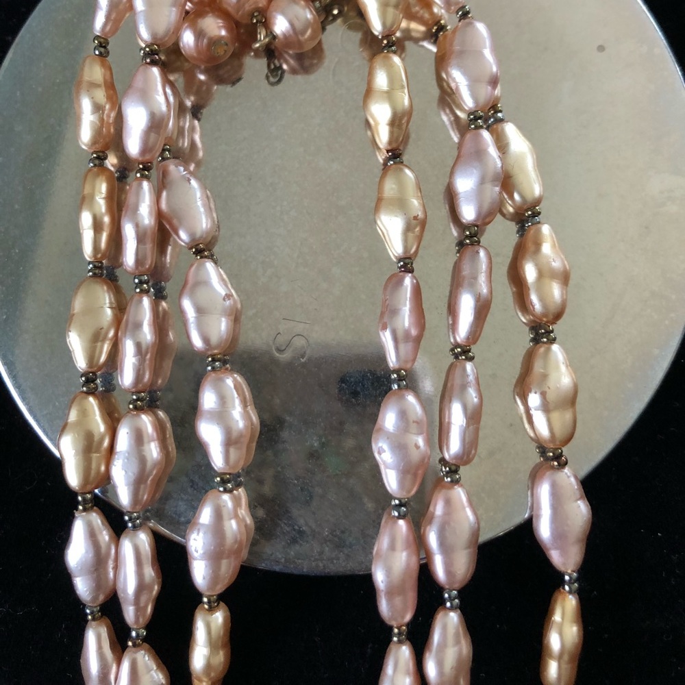 Gold tone pearl bead necklace in triple strand.